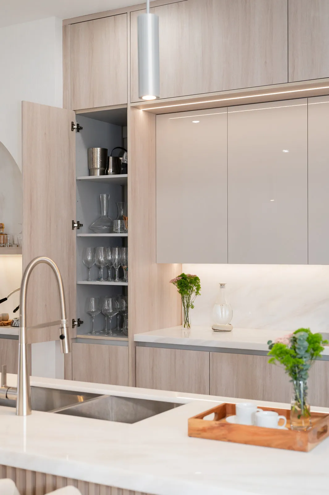 Glass-front pantry cabinet with fluted glass and oak framing, JH Residence kitchen