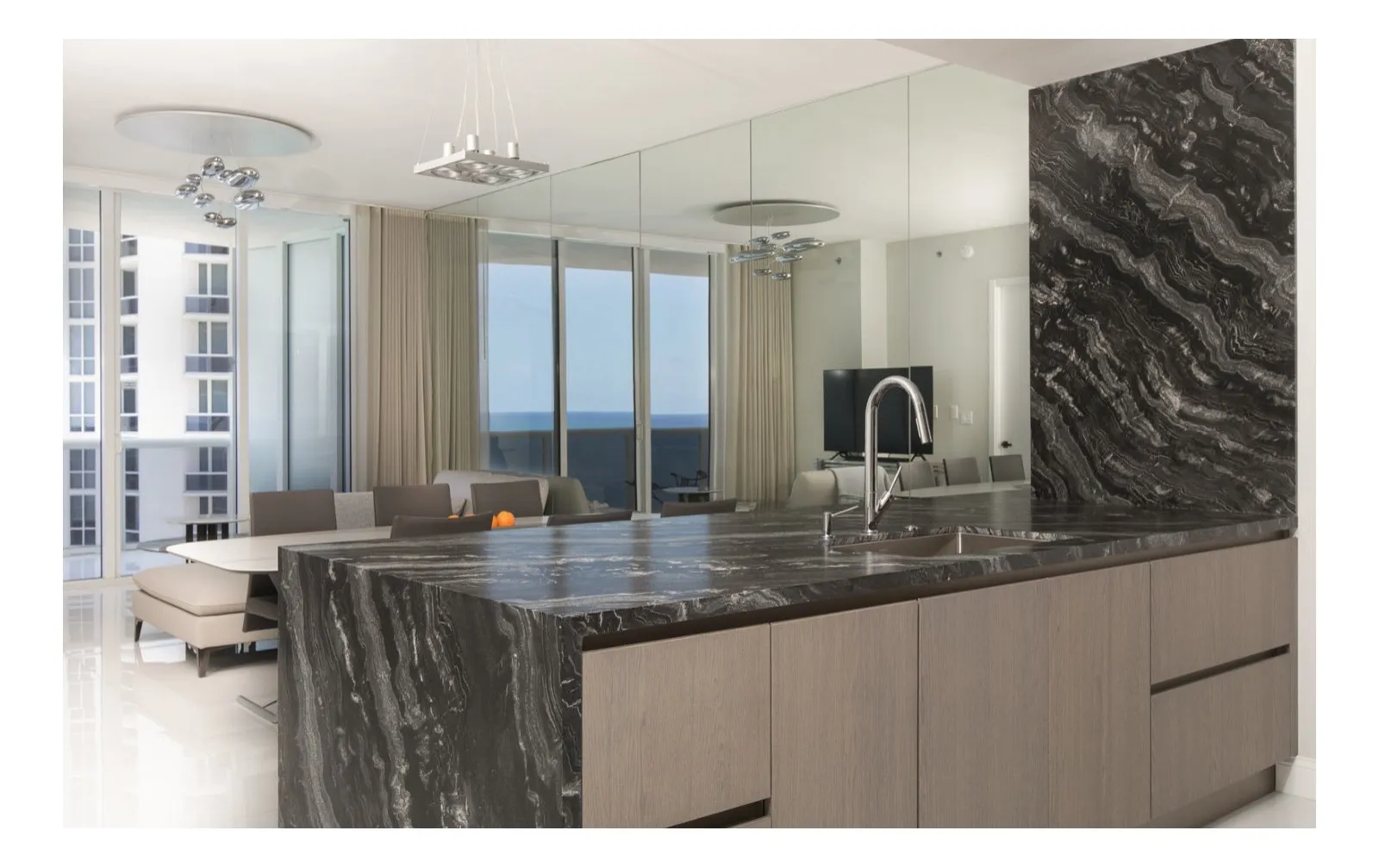 Black marble waterfall island and panel-ready appliances, S Residence